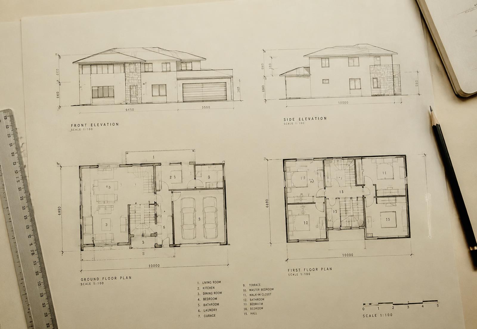 Architectural elevations and floor plans on a drafting table